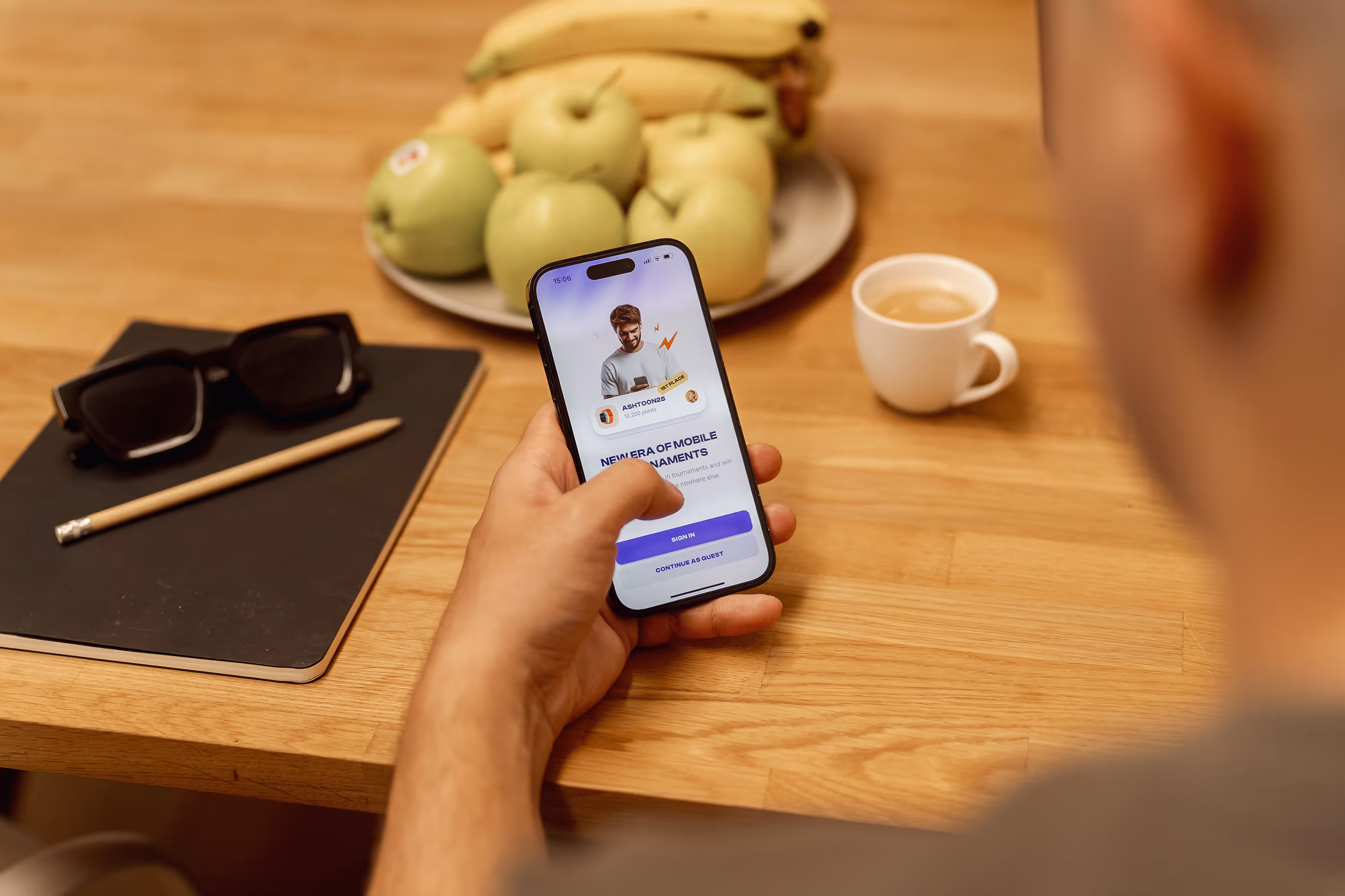 An Outloud team member using a phone at a table